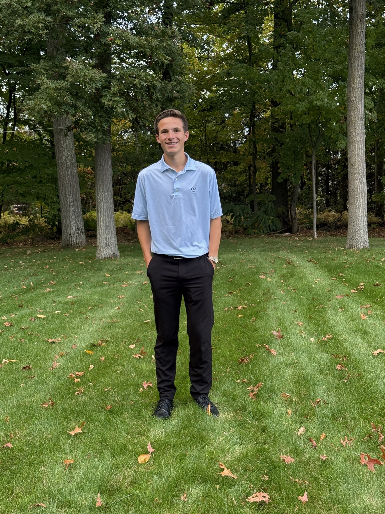 Cameron LaForte smiling on his lawn with trees in the background